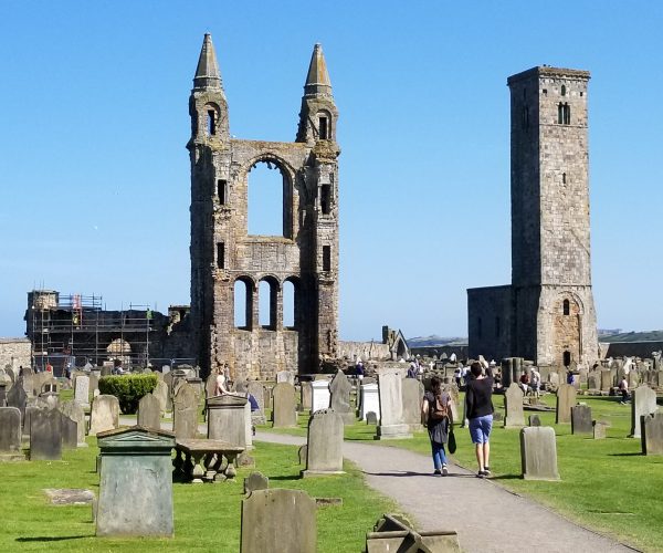 Visitors walking through the ruins of St Andrews Cathedral, Fife, Scotland