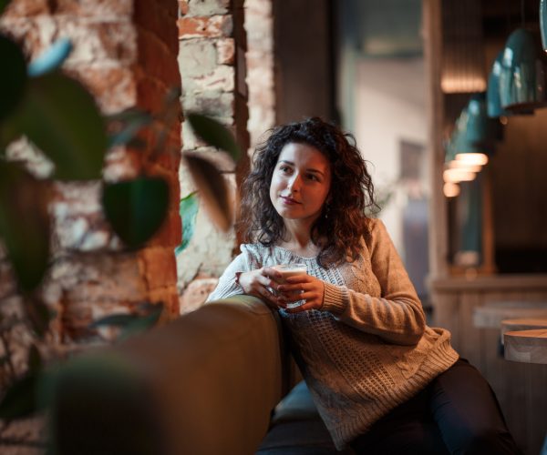 Traveler pausing at a café -- the kind of moment poor travel planning makes you miss, ingenious travel