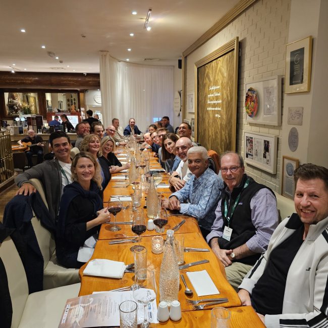 Group golf trip travelers enjoying dinner together at destination restaurant